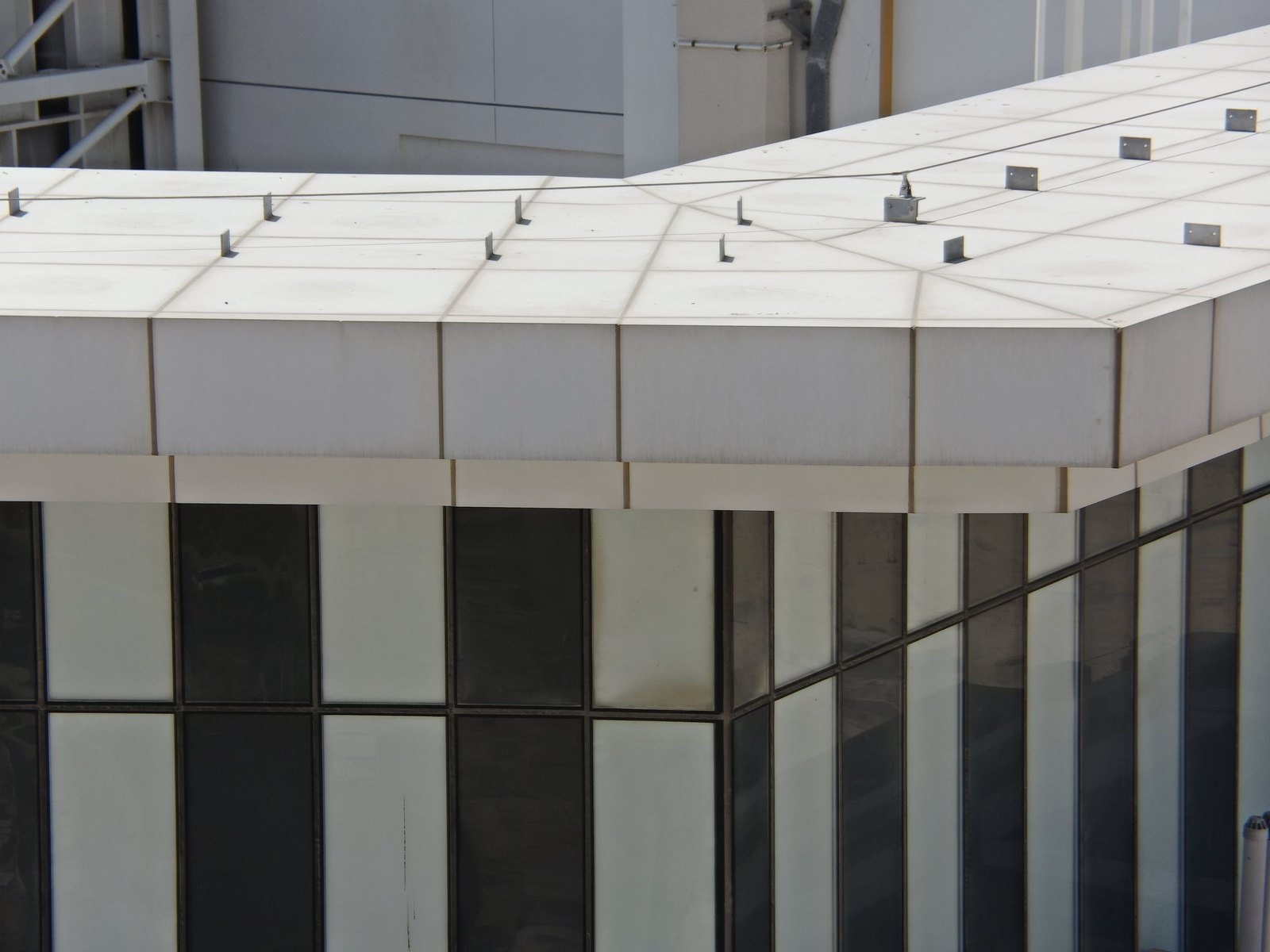 Roof canopy fascia with grey run-off streaks, class overlay on top