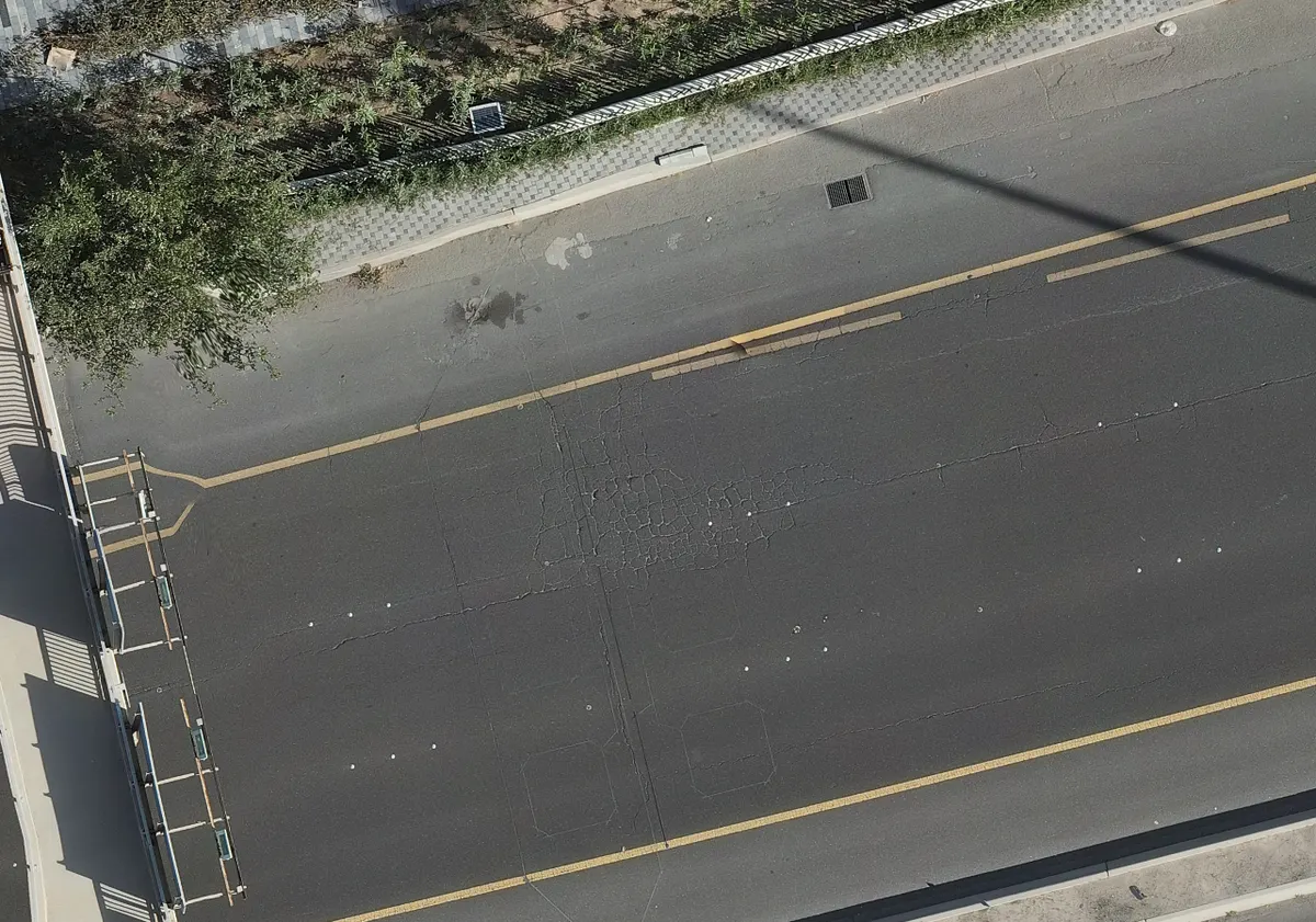Alligator cracking across a traffic lane, outlined
